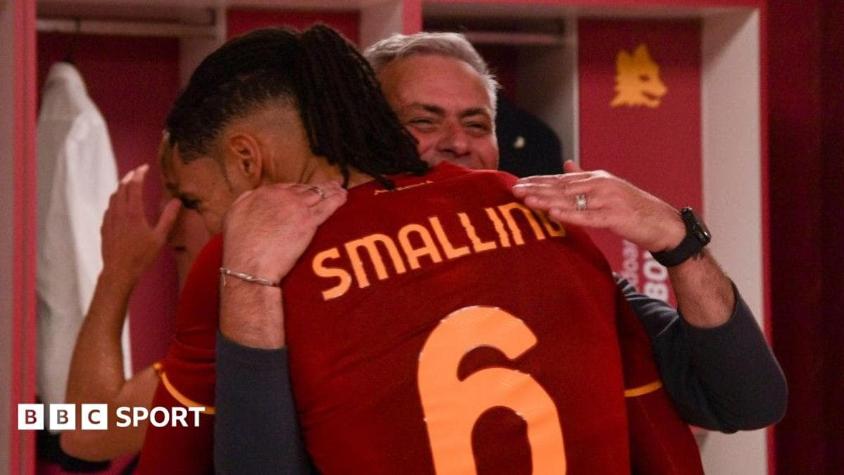Chris Smalling posing with José Mourinho at a football stadium